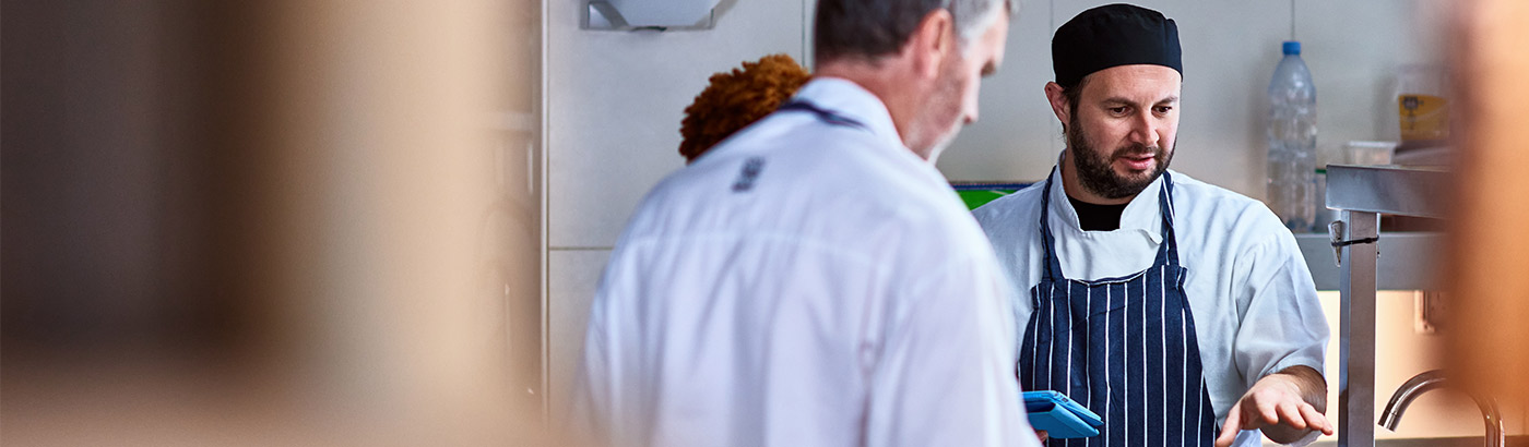 Waiter taking a payment using a Cardnet card machine