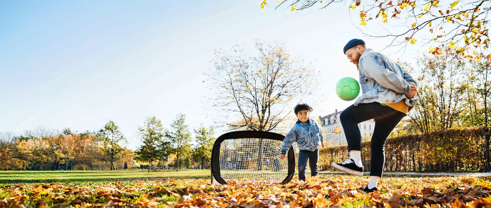 Man and child playing football