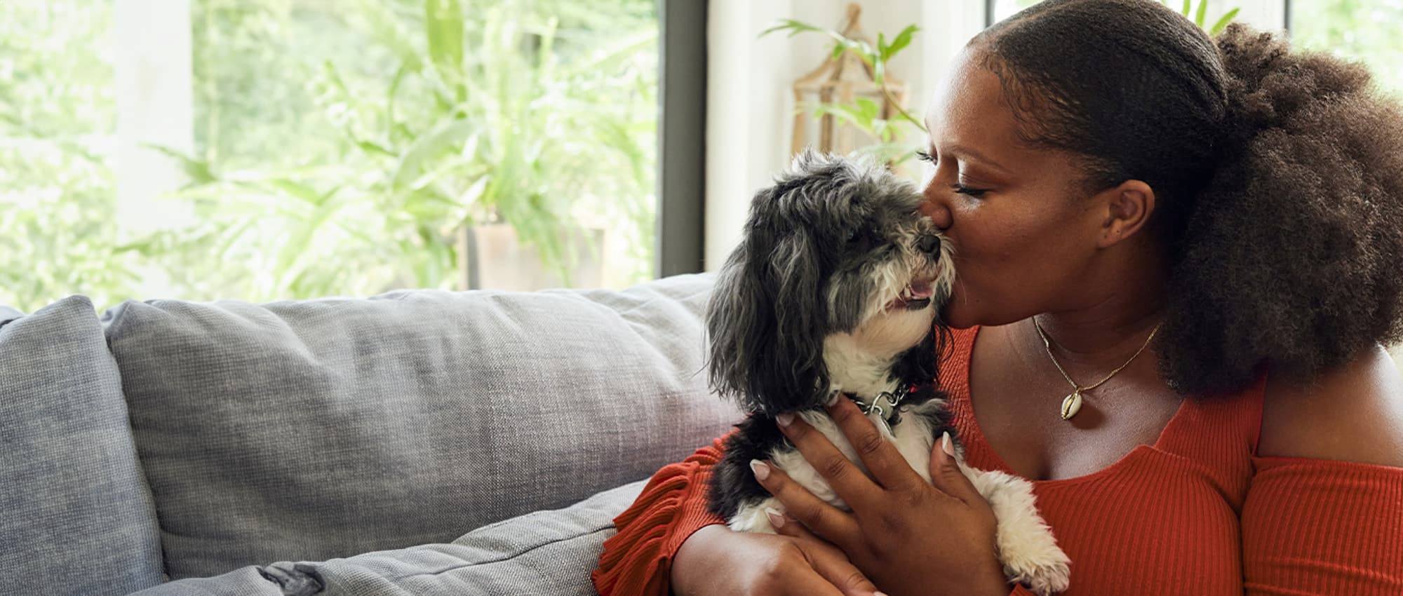 A woman kissing her dog