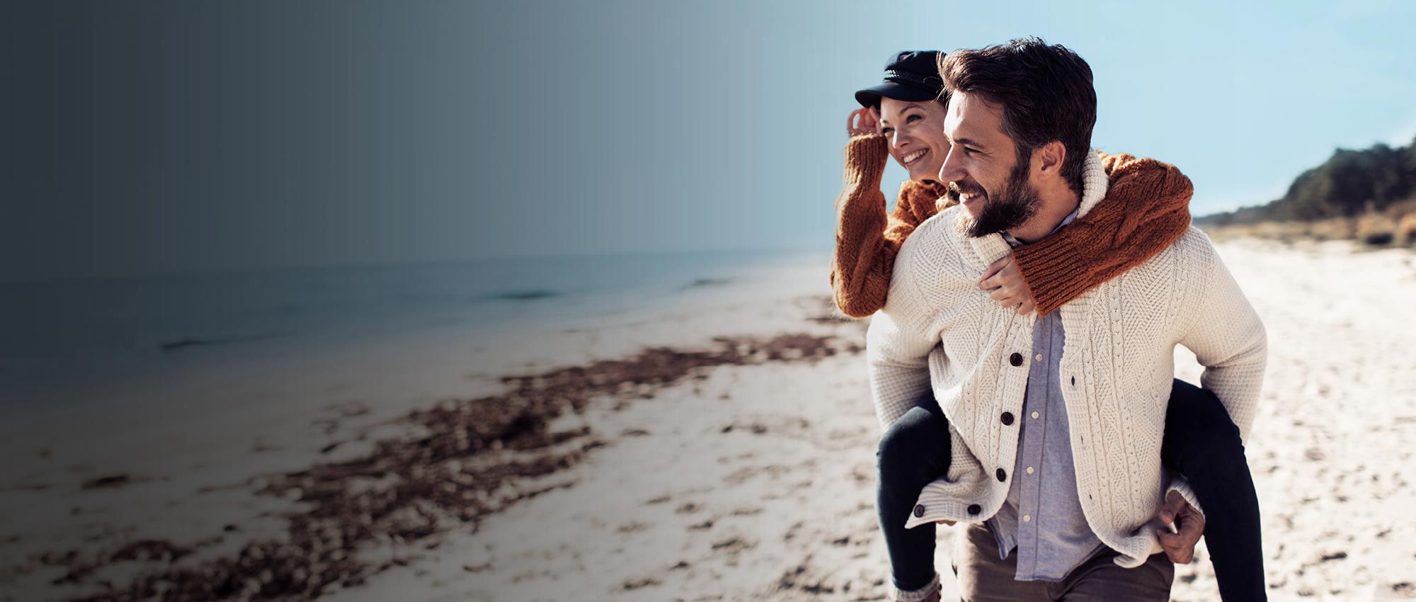 A man and woman on the beach. Caption on the left reads: Islands Personal Banking.