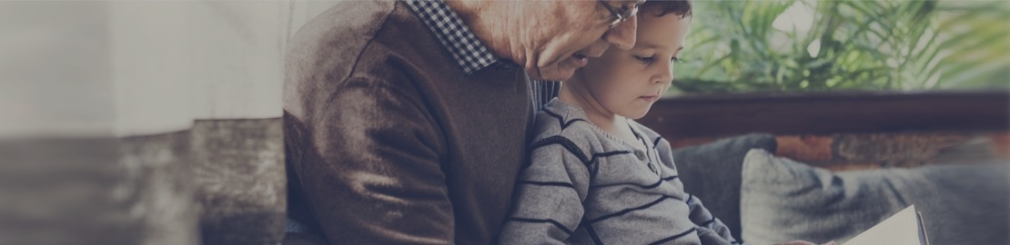 An image of a child reading with grandparent.