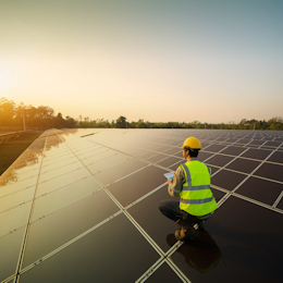 Worker installing solar panels